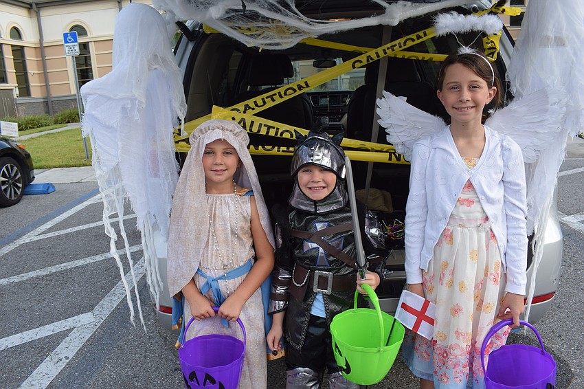 Hannah, 7, Bentley, 6, and Maggie, 11, Smith of Parrish are ready to hand out candy at the Trunk or Treat event.