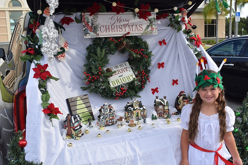 Yes, the season is Halloween, but Mia Morton, 6, dresses as Saint Lucia and reminds everyone that Christmas is coming soon.