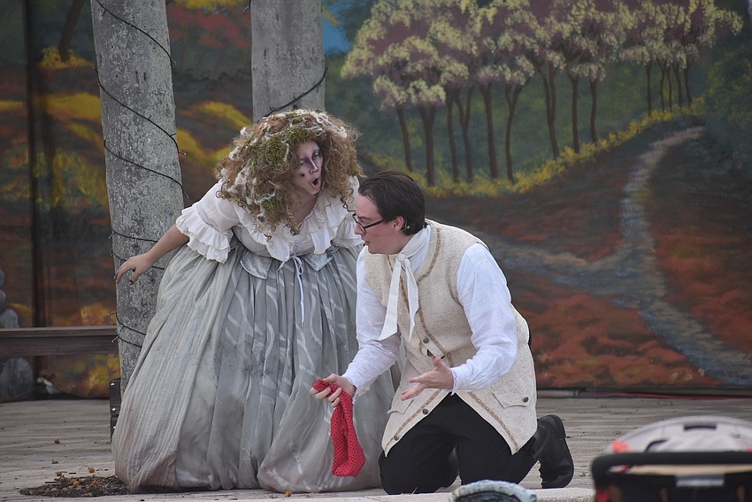 The Woman in White (Abigail Clark) warns Ichabod Crane (Philip Troyer) of incoming danger - namely a visit from the Headless Horseman - in The Legend of Sleepy Hollow.