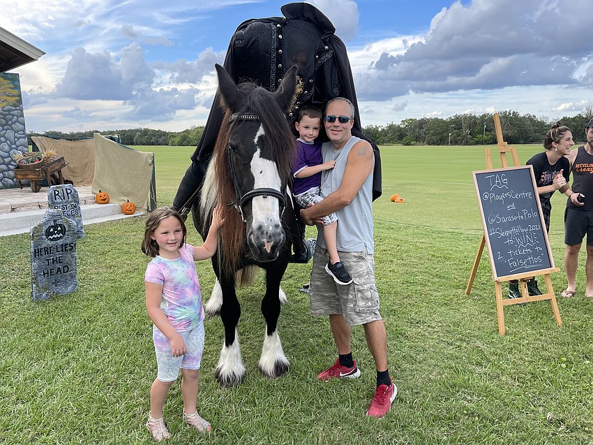Elle, Colton and Chris Zukas, all of Lakewood Ranch, get up close for a visit with the Headless Horseman after Saturday afternoon's show.