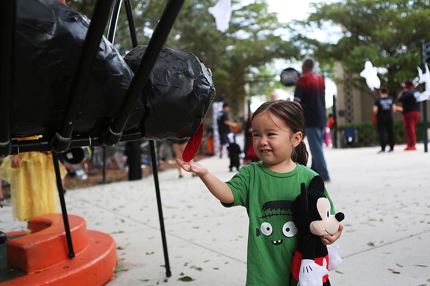 Ariella Rahmas greets the spider at the entrance.