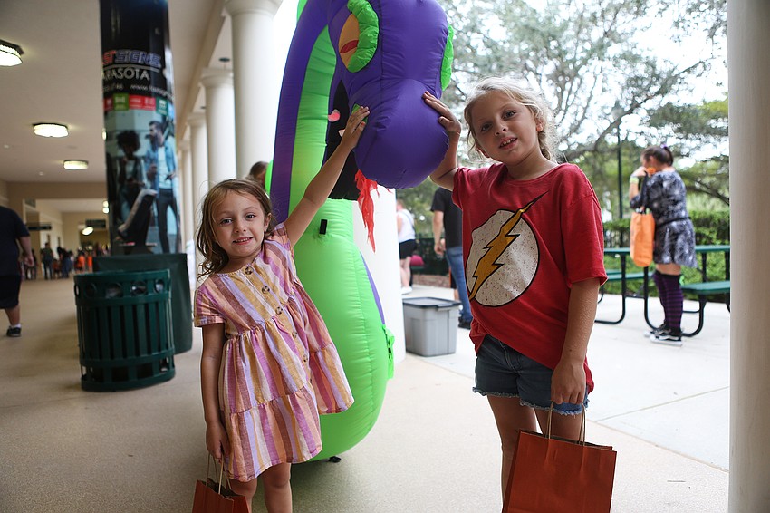 Charlotte and Annabelle Pirozzi pose with a dragon.