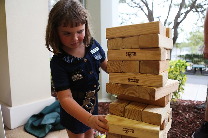 Abbey Granada plays jenga.