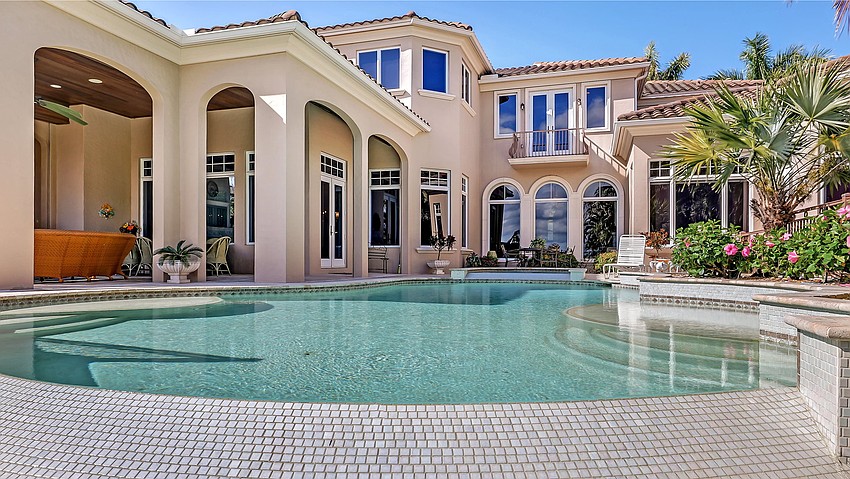 The salt water pool includes  two sunning ledges and a spa.