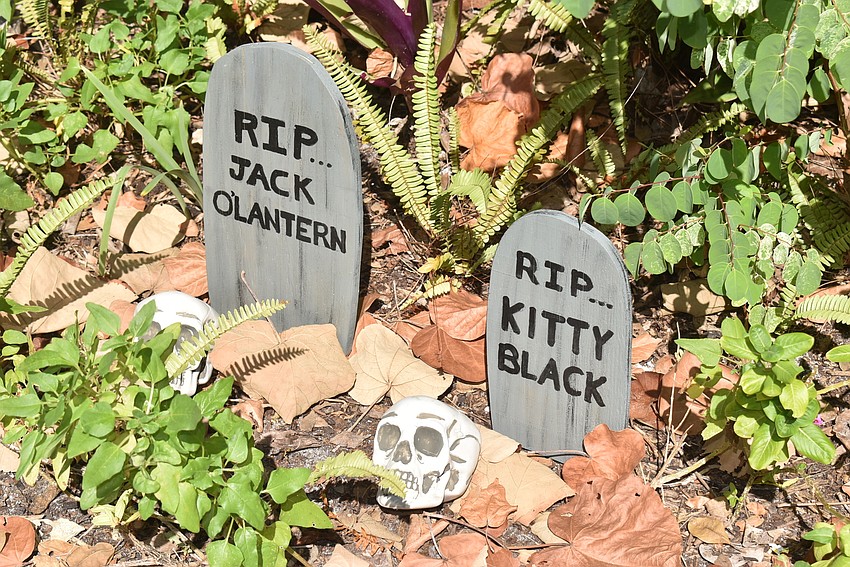 Tiny headstones almost disappear into the foliage at 650 Cedar St.