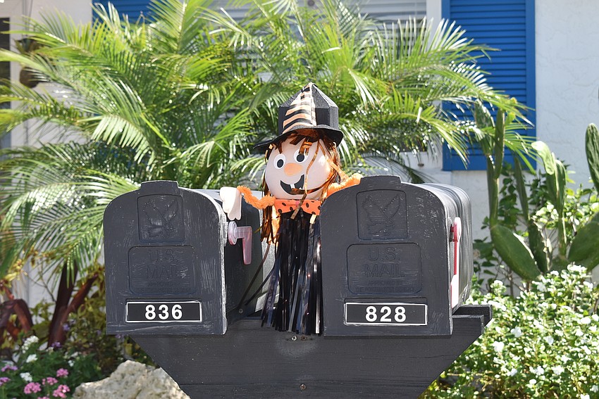 836 Spanish Drive North welcomes the mailman with a friendly witch.