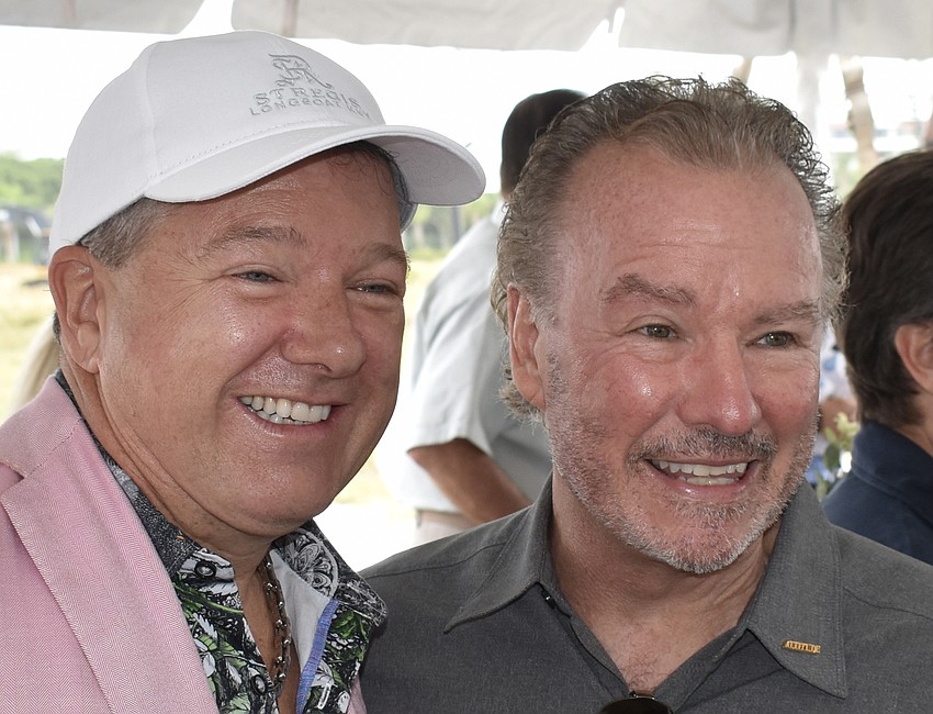 Unicorp National Developments CEO Chuck Whittall chats with Michael Klauber, the son of Colony Beach & Tennis Resort owner  Dr. Murray  