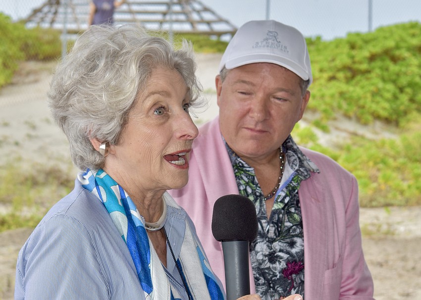 Michael Saunders, founder and CEO of Michael Saunders & Co., addresses the invited guests alongside Unicorp National Developments CEO Chuck Whittall.