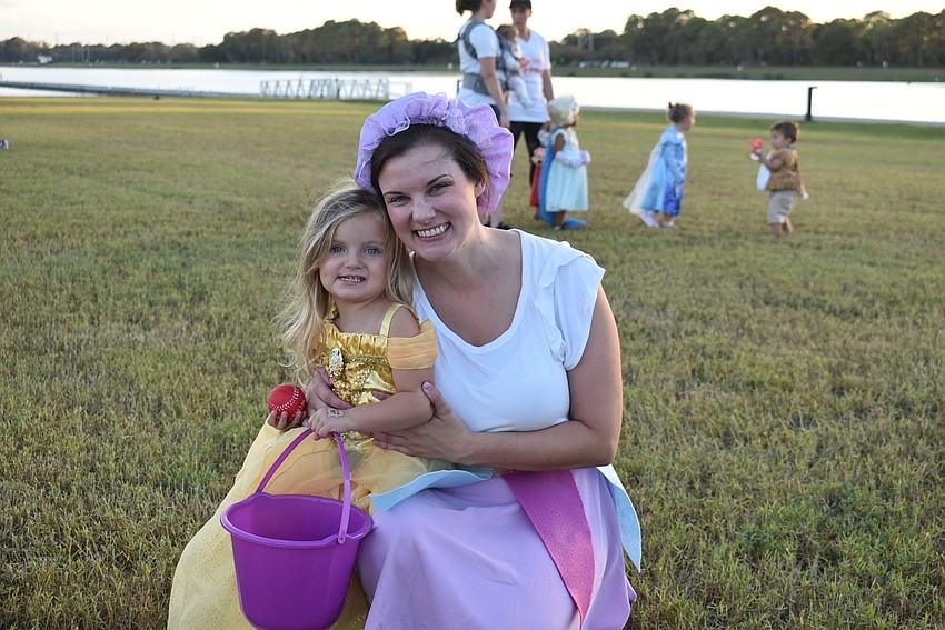 Elova and Audrey Able of Sarasota take in a movie on the south lawn at Tuesday's Trick-or-Treat on the Lake at Nathan Benderson Park.
