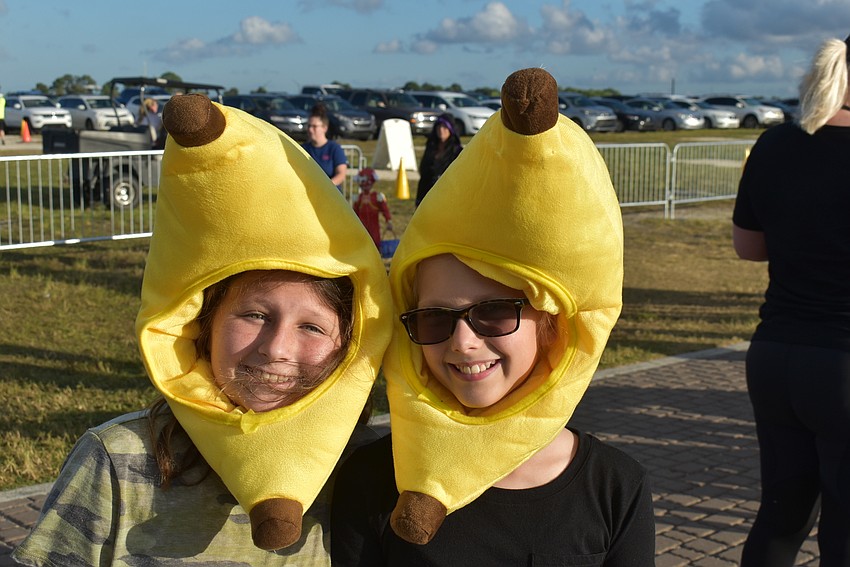 Madelyn Walsh (left) and Rhiley Wetzel, both of Sarasota, drew plenty of attention with their matching banana costumes on Tuesday night.