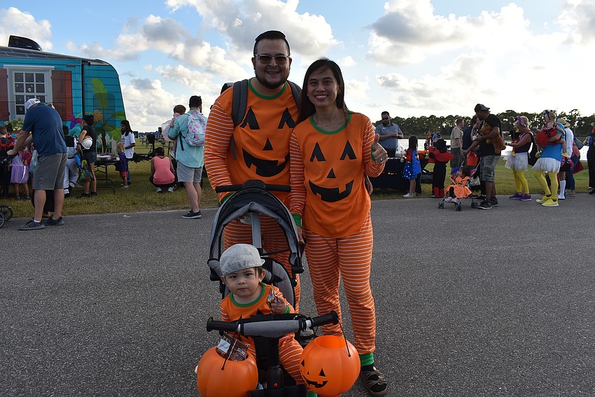 David (left), Alessandro and Tin Caballero, all of Sarasota, were a set of perfectly matched pumpkins at Tuesday night's Trick-or-Treat on the Lake.