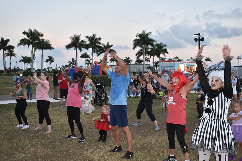 Several members of the audience dance to the music during Tuesday night's Trick-or-Treat on the Lake at Nathan Benderson Park.