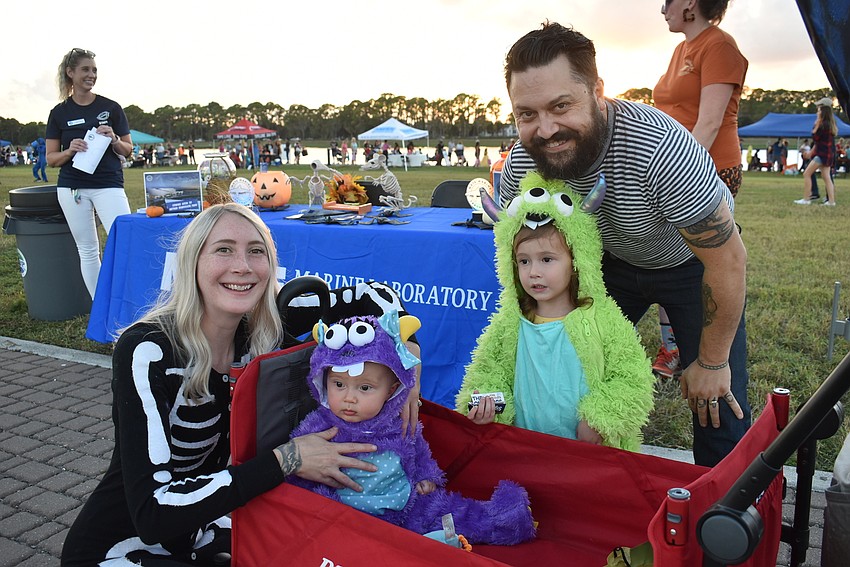 Kayleen Harvey, Juniper Harvey (age 8 months), Emmylou Harvey (3 1/2) and Josh Harvey, all of Lakewood Ranch, take in their first Trick-or-Treat on the Lake.