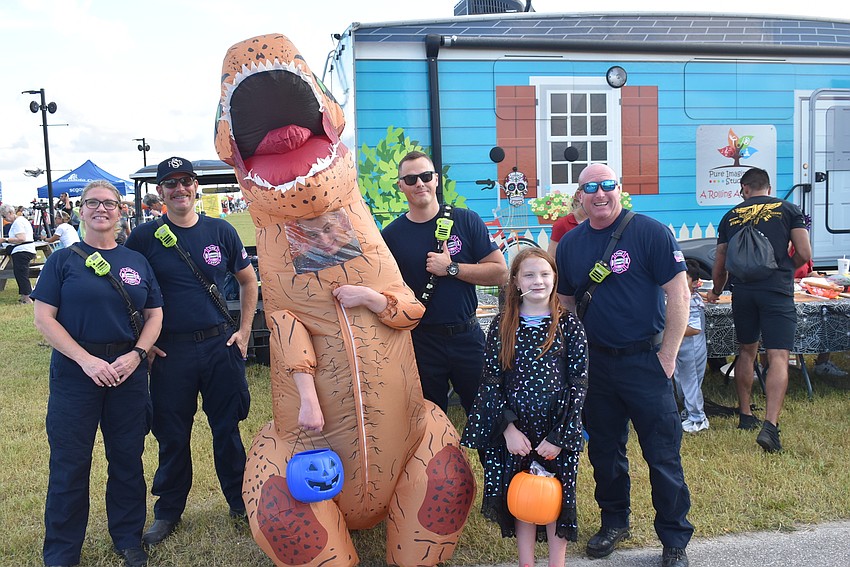 Sarasota's Zackary Morris and Madison Morris ( both in center) drew some laughs from a group of Sarasota County firefighters and paramedics on Tuesday night.