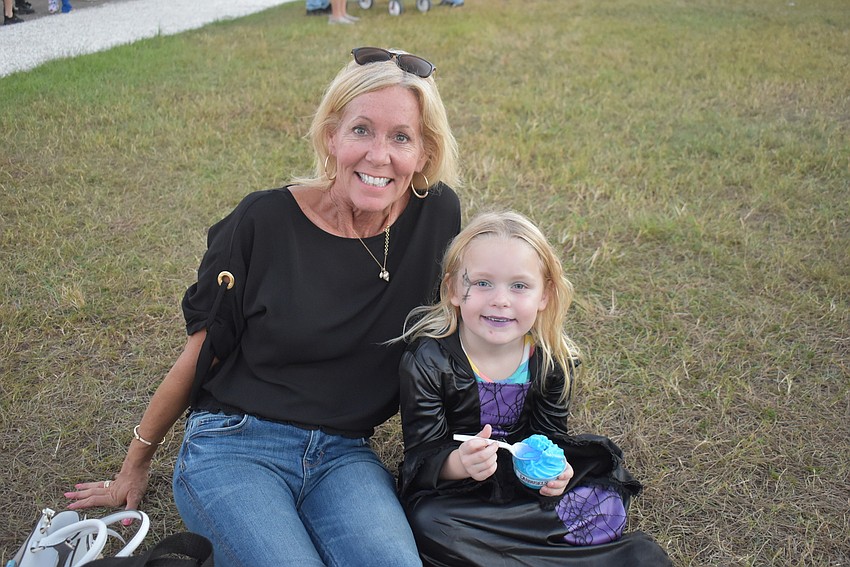 Kathy Bartz (left) and Zoe Bartz of Lakewood Ranch enjoy some music and a blue Italian ice on Tuesday night at Nathan Benderson Park.