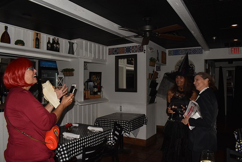 Donna Sharp Blaney snaps a photo of Mary Lou Johnson and Suzy Brenner.