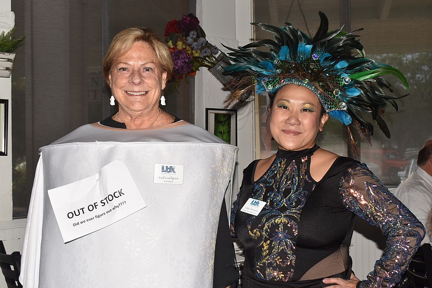 Gail Loefgren as an out-of-stock roll of toilet paper and Caitlyn Zaborowski as a peacock.