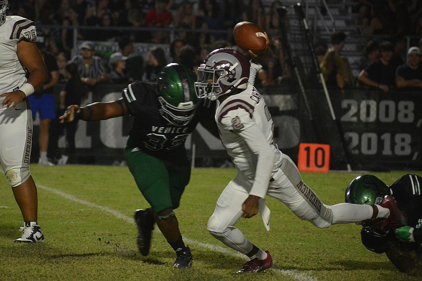 Will Carter Jr. throws a pass while falling down.