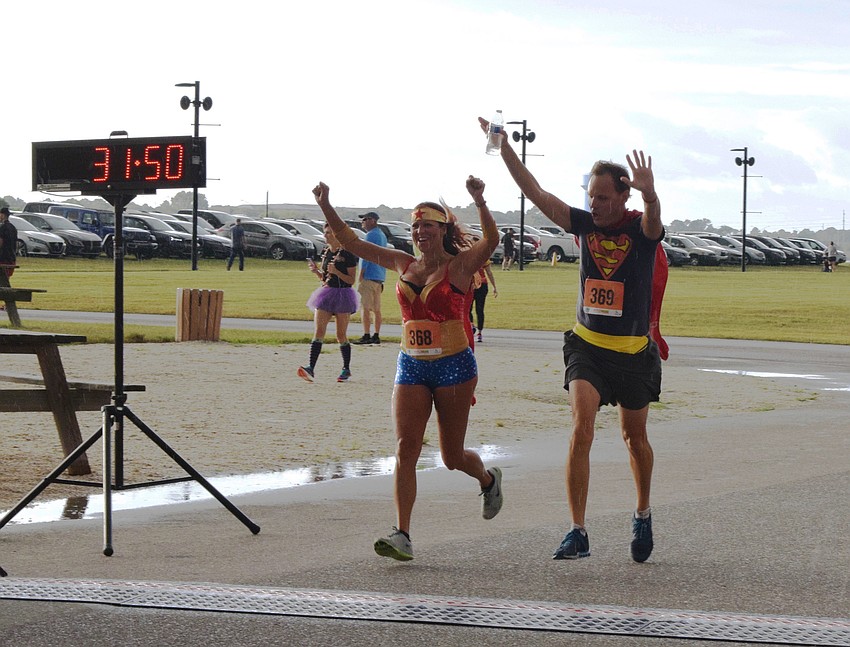Lakewood Ranch's Kerry McManemy and Brad Tanner celebrate crossing the finish line.