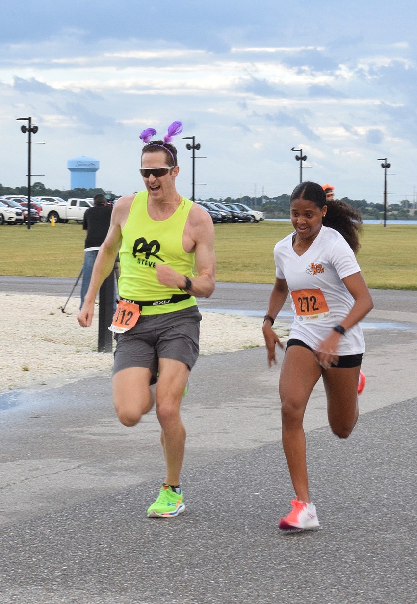 Nokomis' Steven Kane and Layla Haynes, an IMG Academy student, sprint to the finish line trying to beat each other.