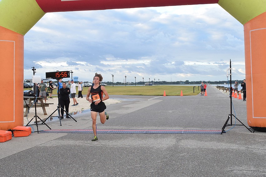 Bradenton's Joshua Bergers is the first to cross the finish line with a time of 15:56.