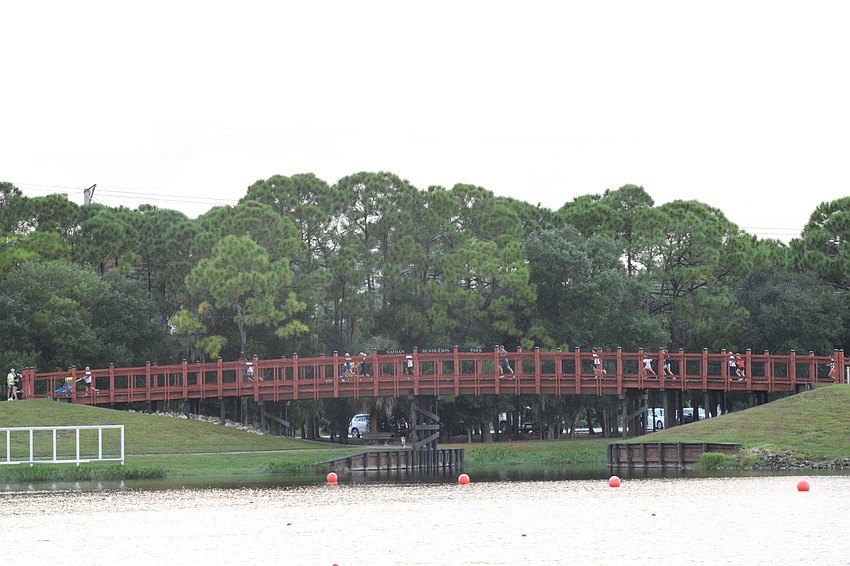 Runners make their way across the bridge during the Boo Run.