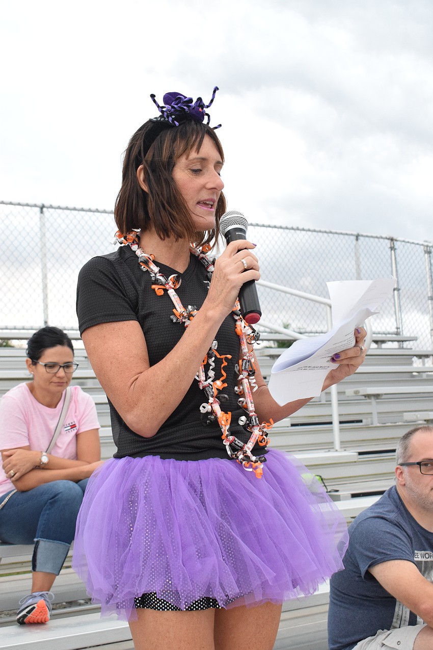 Lakewood Ranch's Jennifer Tullio, who is the Boo Run race director, greets race participants.
