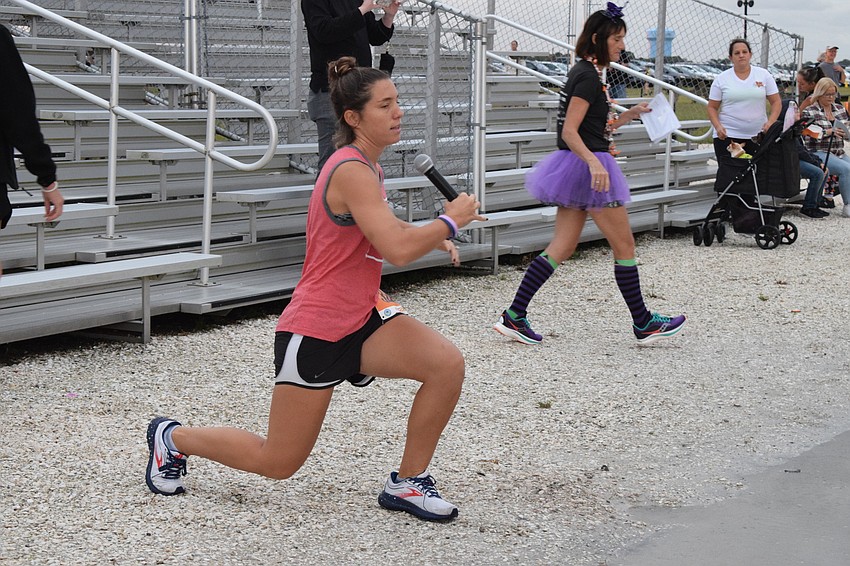 Central Park's Liz Gutierrez leads race participants in exercises before the race.