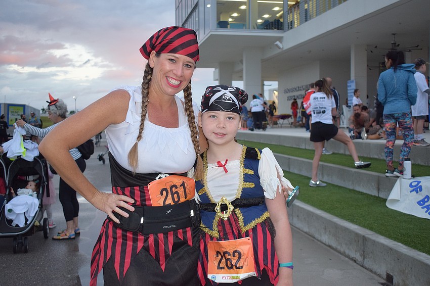 Nokomis' Jasynda Davis and her 8-year-old daughter Leah Davis dress as pirates for the Boo Run in hopes of wining the costume contest.