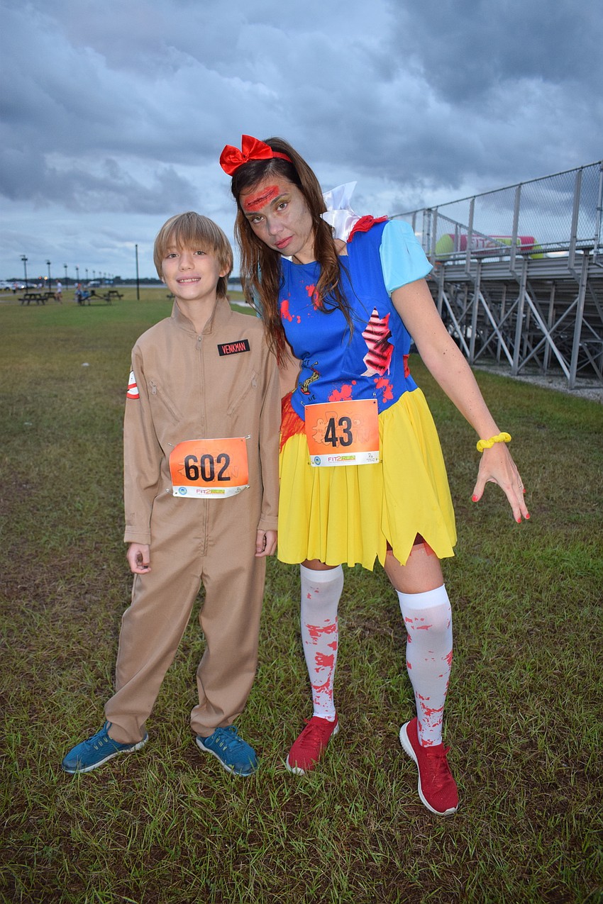 Sarasota's Vitor Essenfelder, who is 13 years old, and Dominike Essenfelder get ready for the Boo Run.