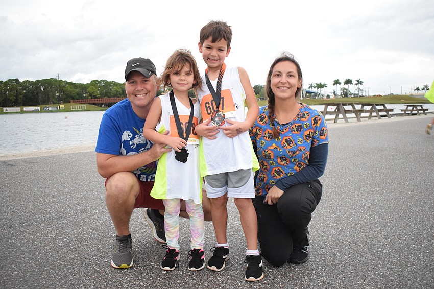 East County's Craig Fisher celebrates with his children, 5-year-old Hope Fisher and 6-year-old Xavier Fisher, and his wife Shannon Keever. Hope and Xavier Fisher competed in the Boo Dash.