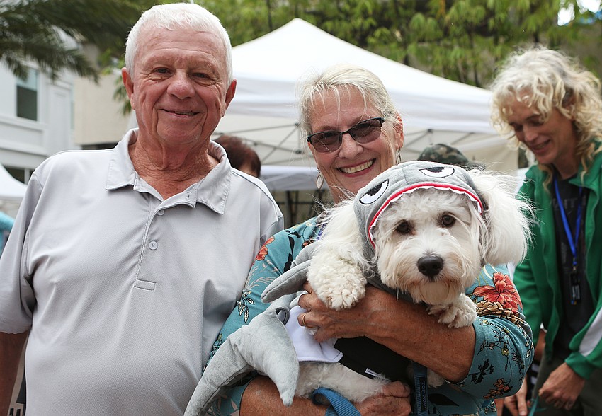 Eddie and Cass Smith hold up Ollie, the shark.