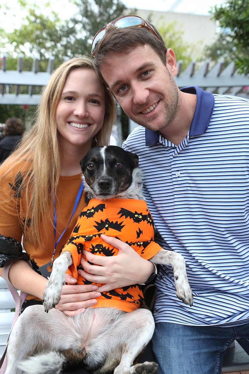Kelly Sivyer and Zach Tutterow hold Pearl in her sweater.