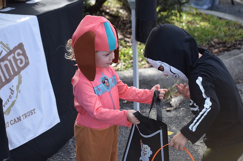 Lakewood Ranch 2-year-old Weslyn Sierra shows her Halloween bounty to Lakewood Ranch 4-year-old Leo Dinapoli.
