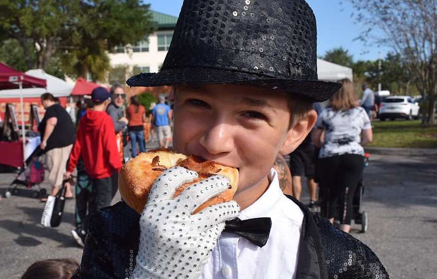 Lakewood Ranch 10-year-old Austin Kochanskyj, as Michael Jackson, rips into a bagel. Kochanskyij said he used to moon dance, but now he is 