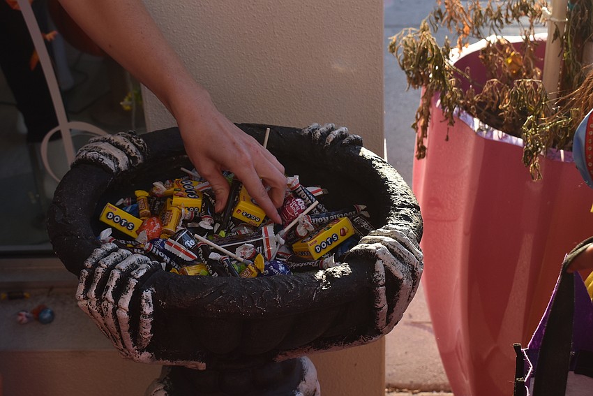 Brianne Wilson doles out candy at Apricot Lane Boutique.