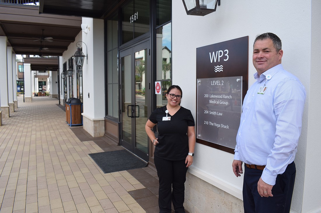Office Manager Maria Patino and Dr. Duane Johnson enjoy being with the first business to open at Waterside Place: The Lakewood Ranch Medical Group.