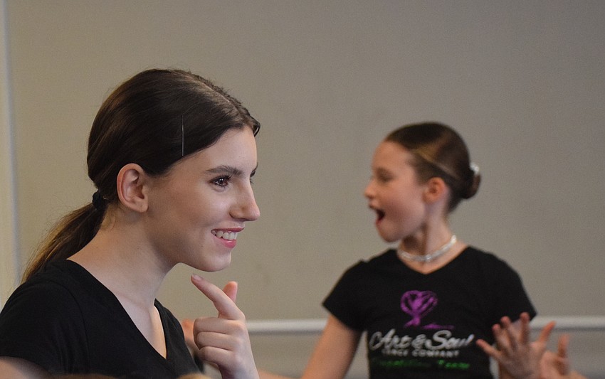 Claire Gonzales does a routine with Meadow Edoff in the back. Gonzales says she will channel her nervous energy in a positive way.