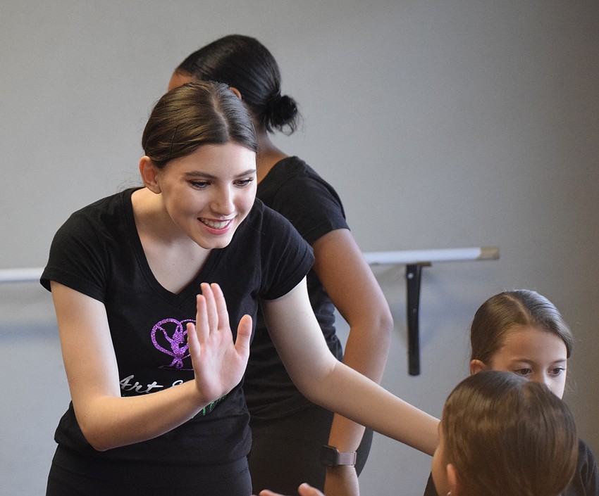 Claire Gonzales gives her teammate encouragement during a workout.