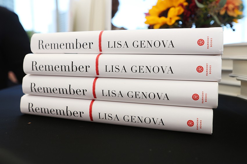 Attendees has copies of books by Lisa Genova signed.