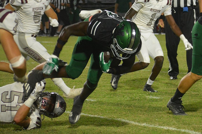 Eli Renick (51) trips up DJ Escort in the first quarter. The Rams tied Venice 7-7 in the first half before losing 42-7.
