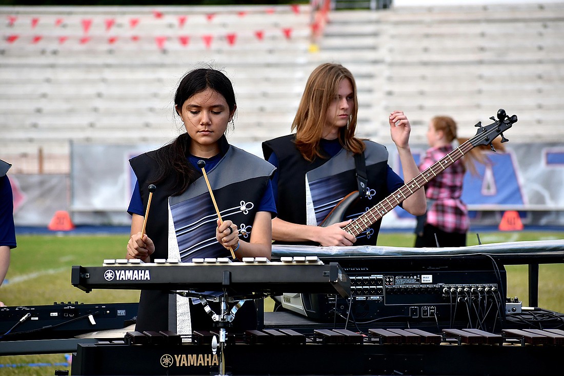 Samantha Flores and Kyle Vaske play with the front ensemble during the Pride of Parrish Marching Band&#39;s performance of its show Flourish. Courtesy photo.