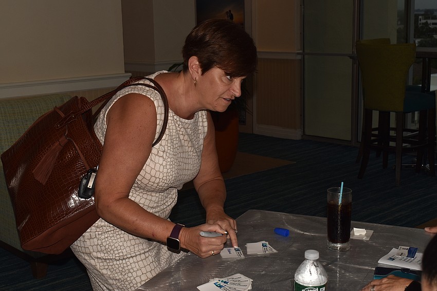 Melanie Dale fills out a nametag.