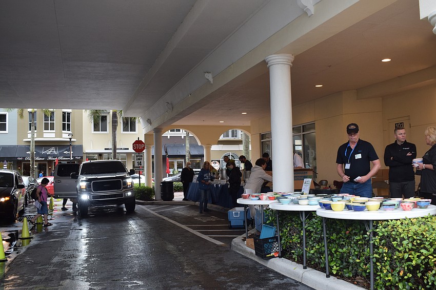 Cars come through the drive thru Empty Bowls event. Empty Bowls was supposed to be held in-person, but the rain caused Meals on Wheels Plus of Manatee to change it to a drive-thru event.
