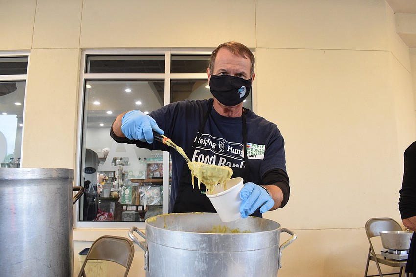 Heritage Harbour's Mike Neville serves curry soup.