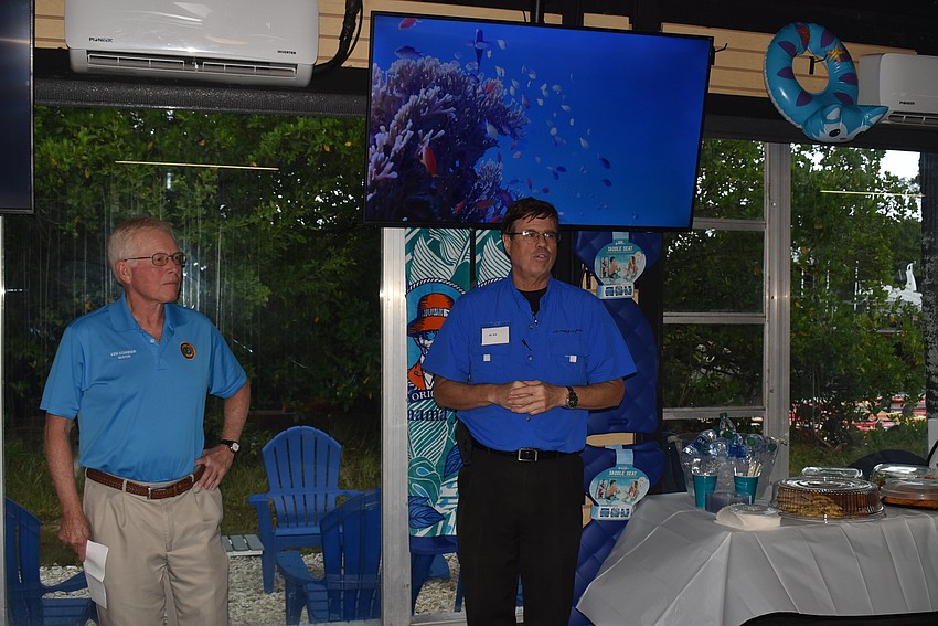 Ed Kolodzieski welcomes attendees to the store while Mayor Ken Schneier stands by.