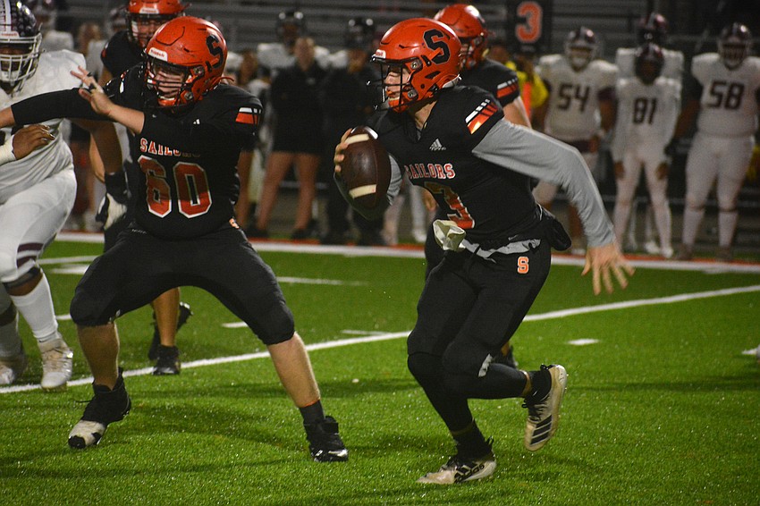 Sailors quarterback Lance Trippel scrambles out of the pocket.