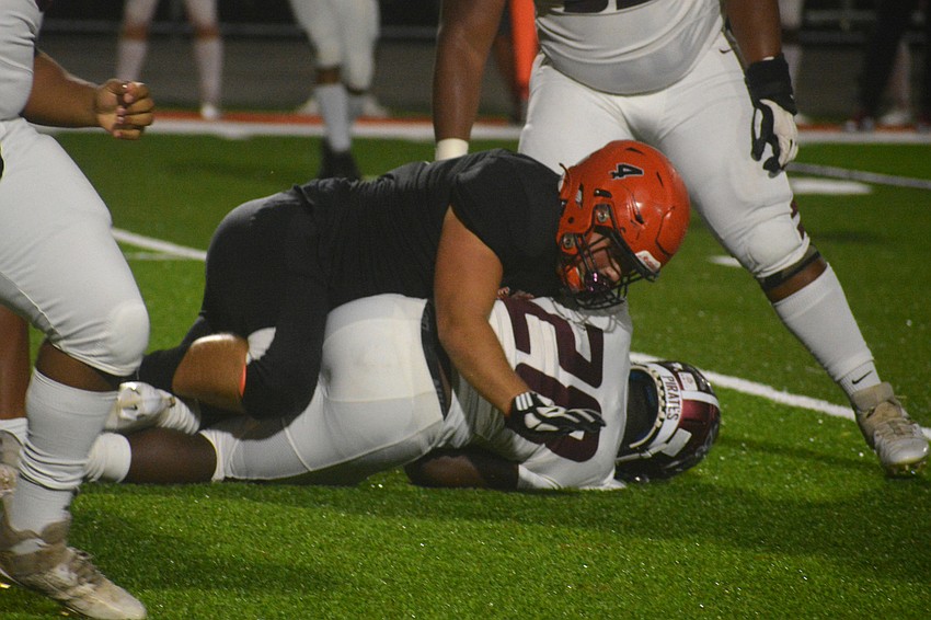 Sailors defensive tackle Maddox Marchbank tackles Braden River running back Trayvon Pinder.