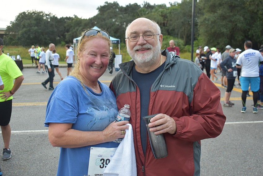 Lauren Hadley (left) and Tom Keeler of Sarasota share a moment at the finish line after Saturday's Fort Hamer Bridge run.