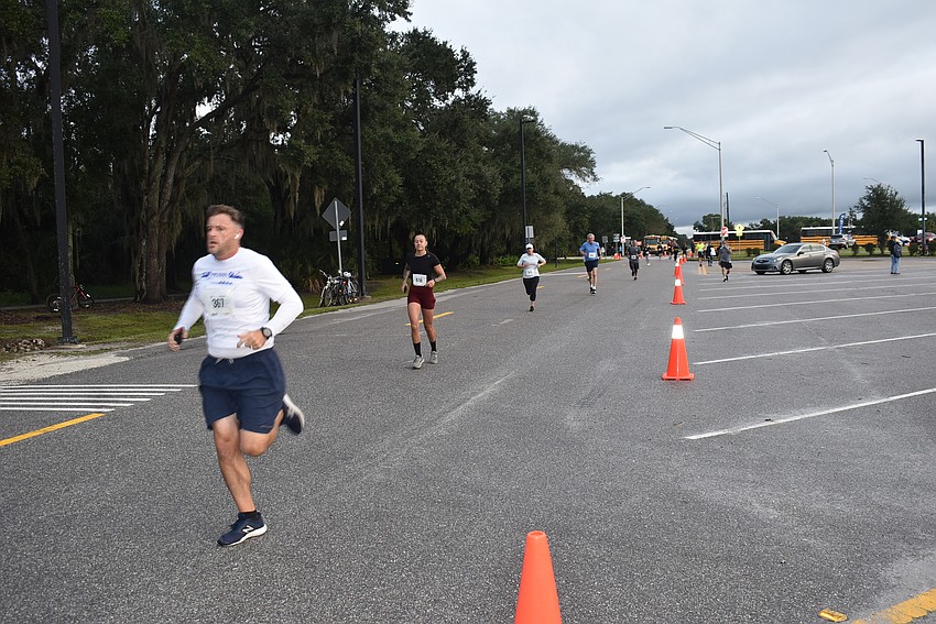 Kevin Luehrs Sr. leads a group of runners down the home stretch of Saturday's Fort Hamer Bridge Run.